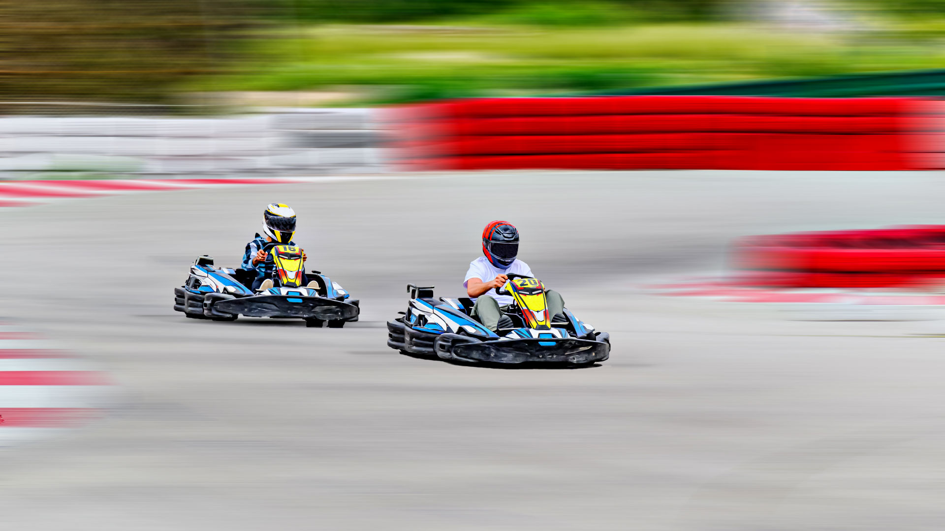 Two go-karts racing closely around a corner.