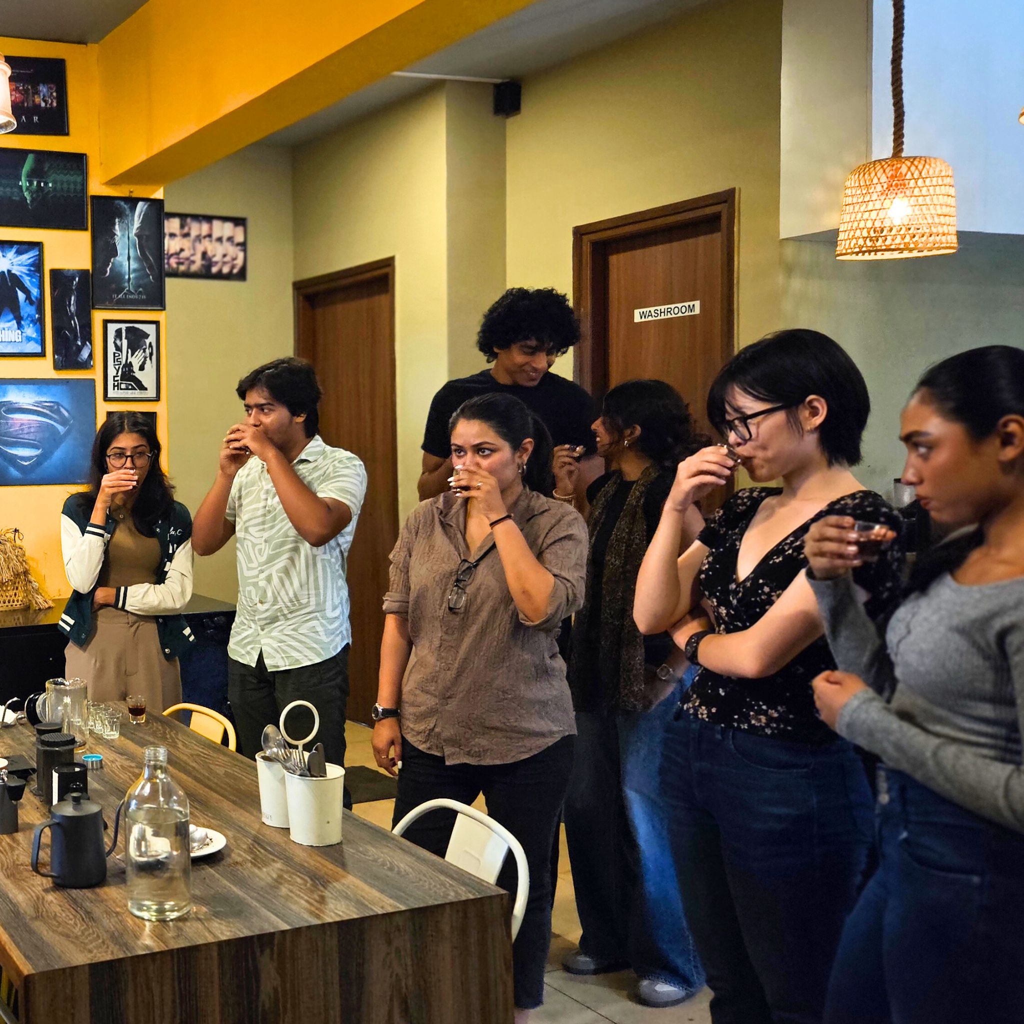 Group of participants tasting coffee, discussing and enjoying the experience together.