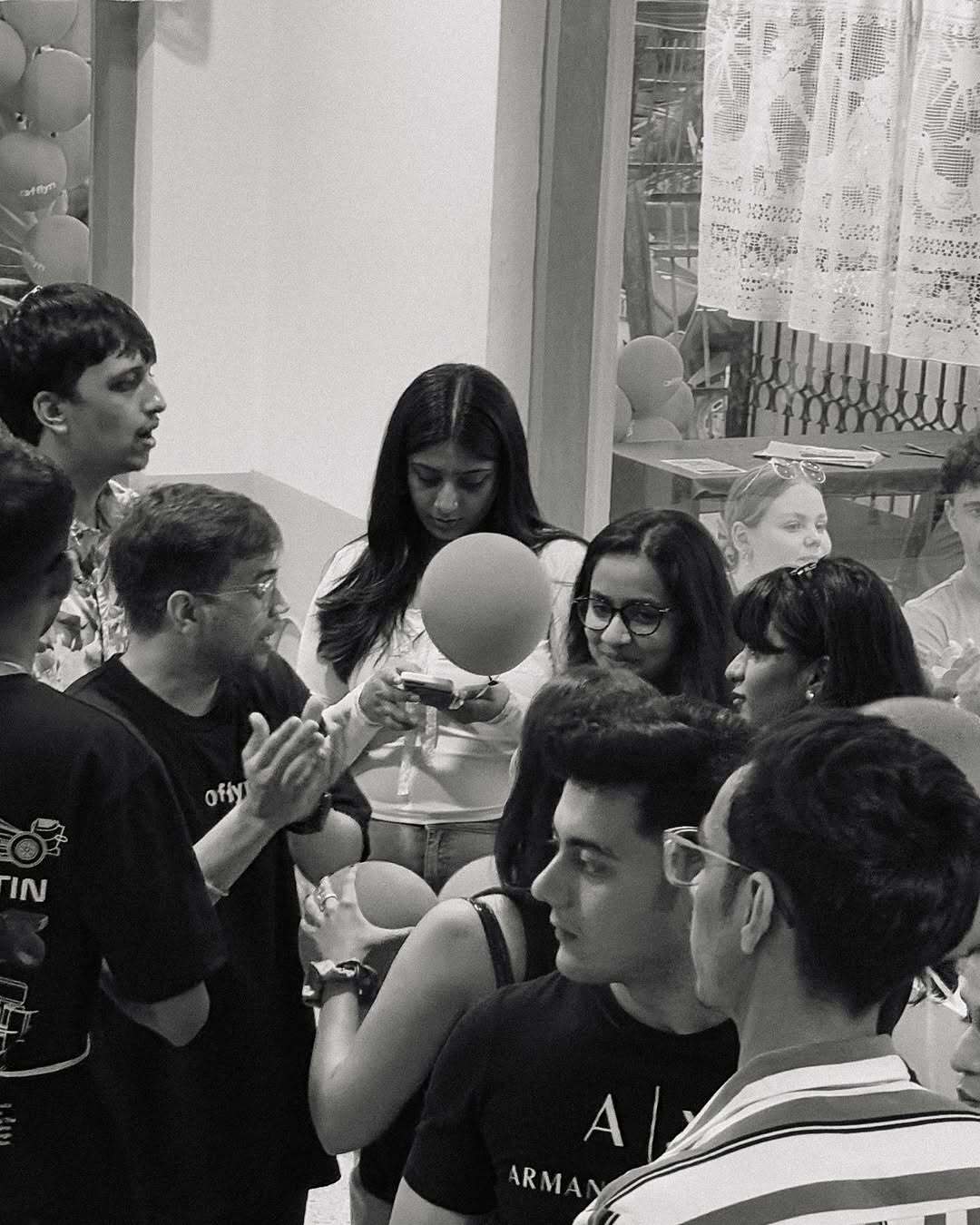 Group of people gathered enjoying an authentic German dining experience indoors with festive balloons