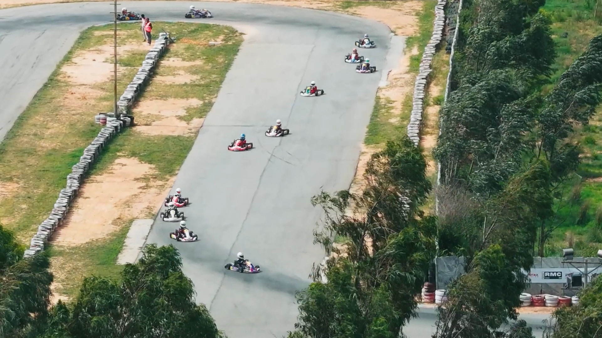 Aerial view of several go-karts on a racing circuit.