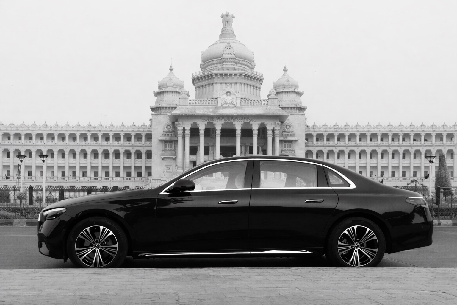 Black Mercedes car parked in front of grand architecture showcasing luxury and elegance