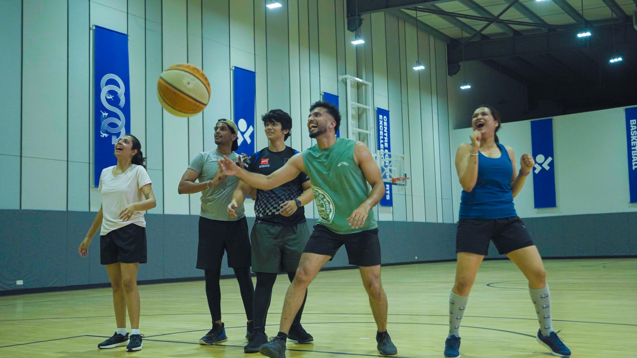 Male player smiling while dribbling the basketball in Bengaluru