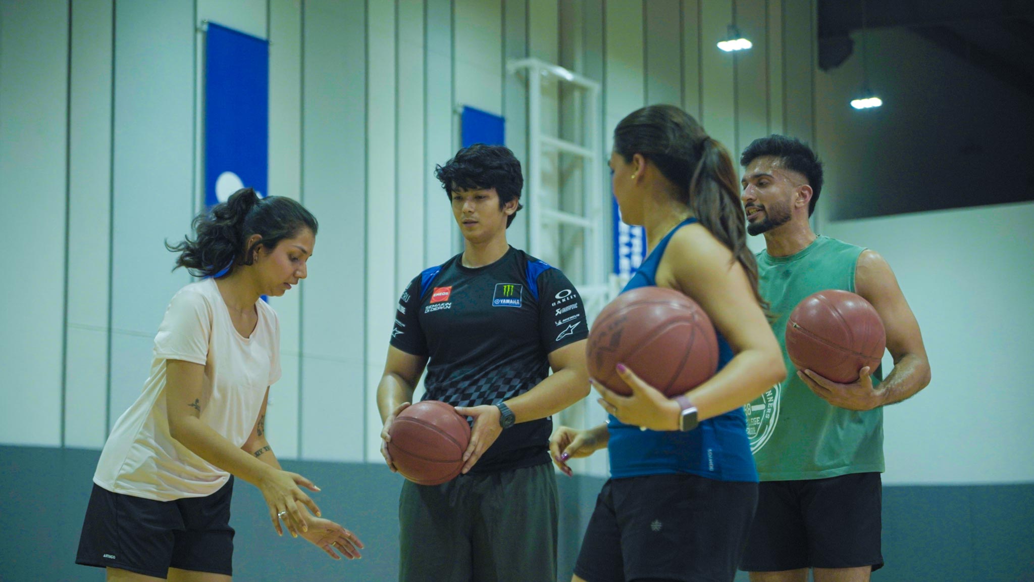 Player preparing to shoot a basketball in an indoor basketball court in Bengaluru.