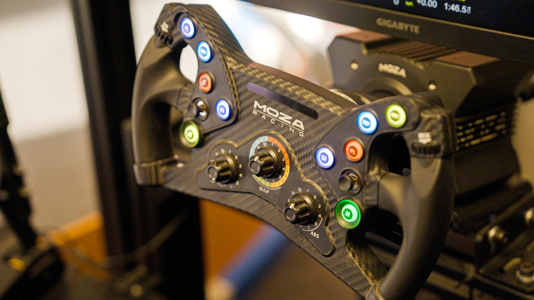 Detailed view of the MOZA Racing carbon fiber steering wheel with multiple controls.