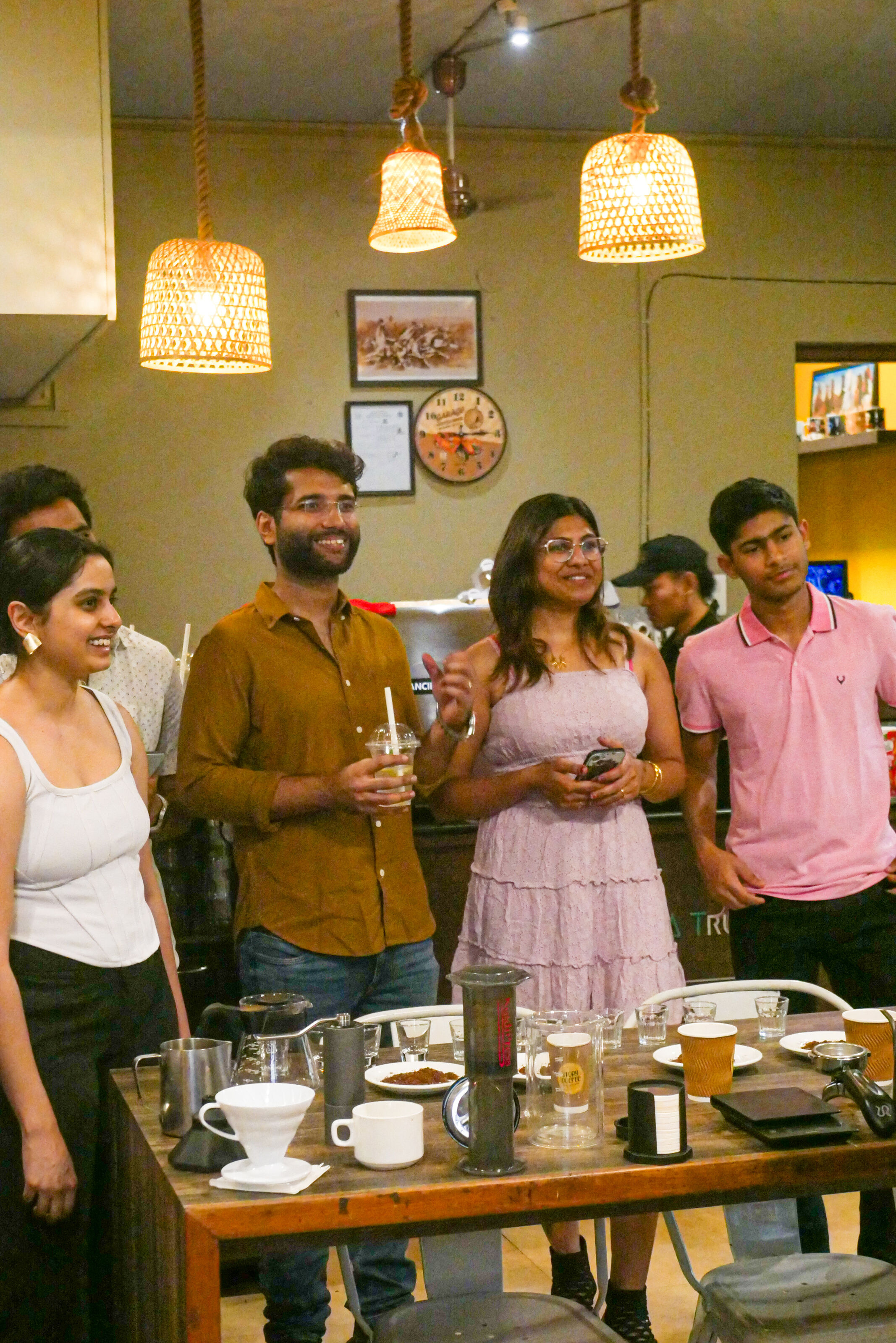 Group enjoying and engaging in the coffee brewing experience together in Chennai.