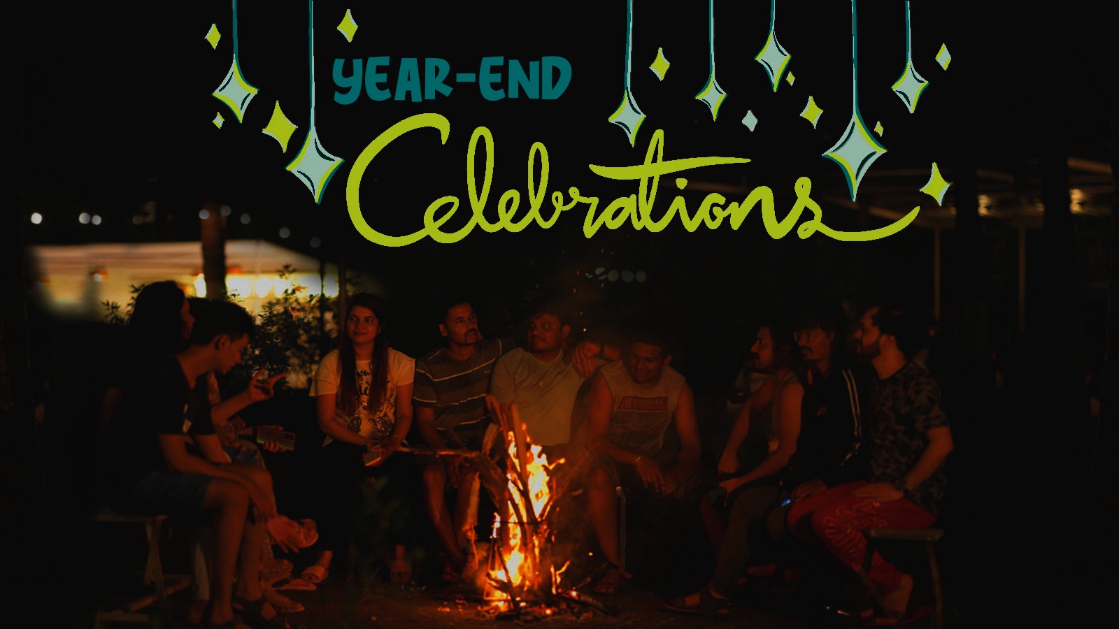 Year-end celebrations with group sitting around campfire sharing moments under starry night.