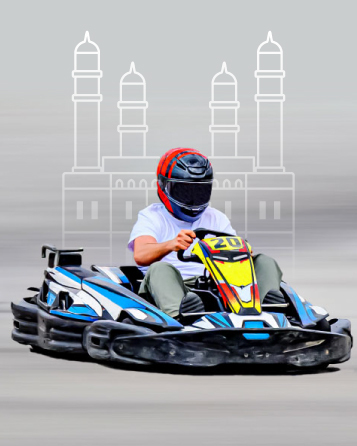 Person in helmet driving a colorful go-kart with a blurred background featuring a monument outline.