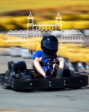 Individual speeding in a black go-kart with a blurred background, highlighting the thrilling experience at Alive - Mumbai.