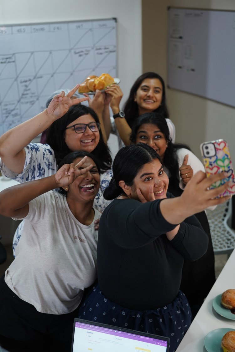 Smiling friends taking a selfie together during a lively German-style food celebration