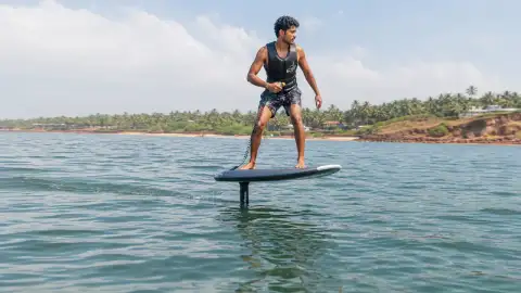 Gallery scene: a rider turning gently across the surface, body angled for balance, capturing.